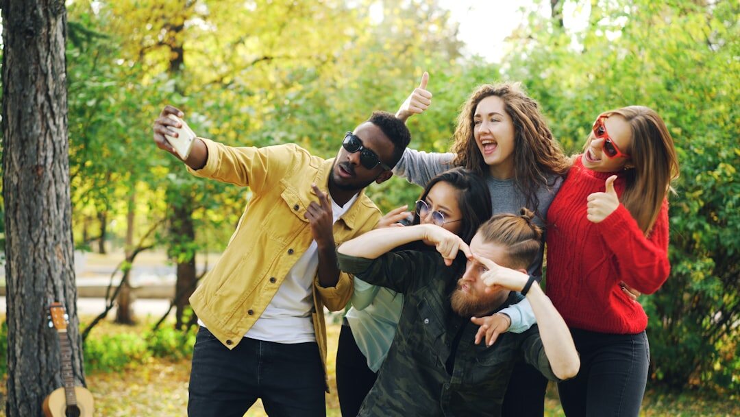 Colleagues cheering during an outdoor team building activity in a park