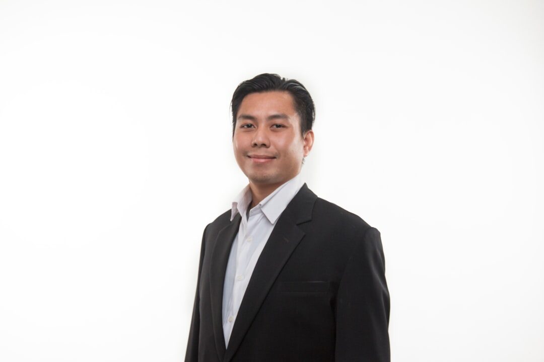 Studio portrait of an Asian man in his 30s, client relations manager